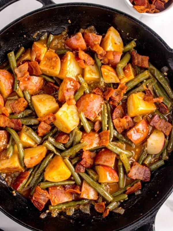 Completed green bean recipe in a cast iron pan.