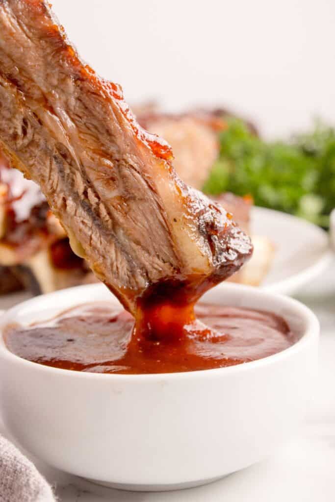 Beef rib dipped in barbecue sauce.