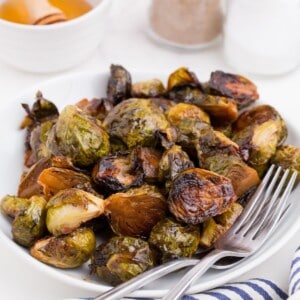 Completed brussels sprouts recipe on a white dinner plate.
