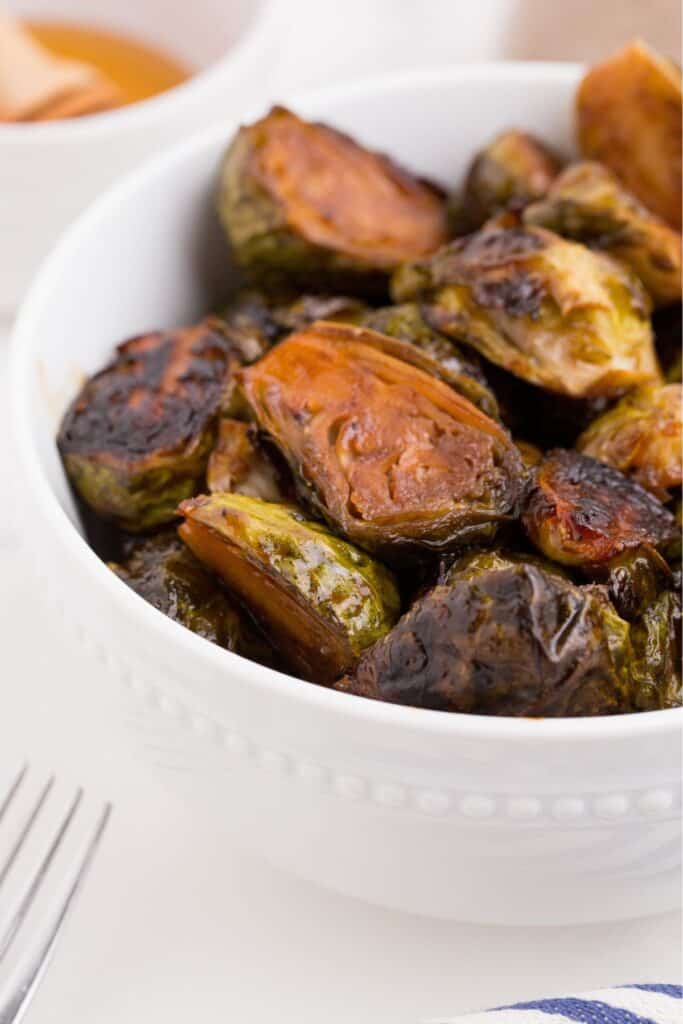 A small serving bowl with cooked brussels sprouts.