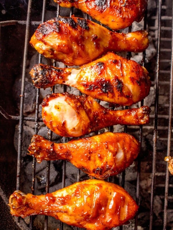 Chicken legs cooking on the grill.