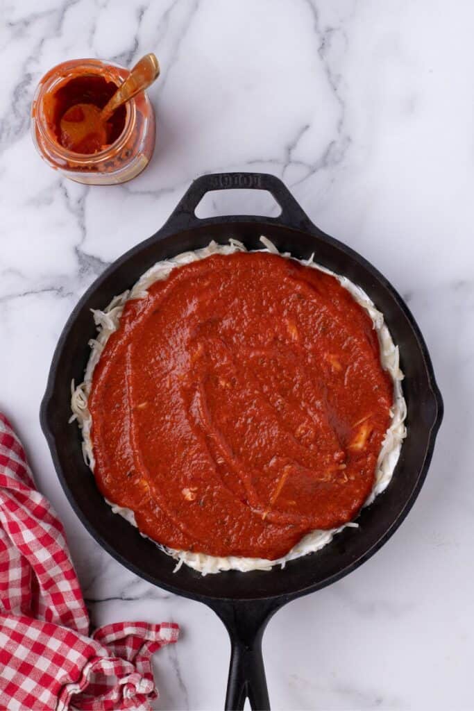Pizza Sauce is layered on top of the mozzarella cheese and cream cheese layers.