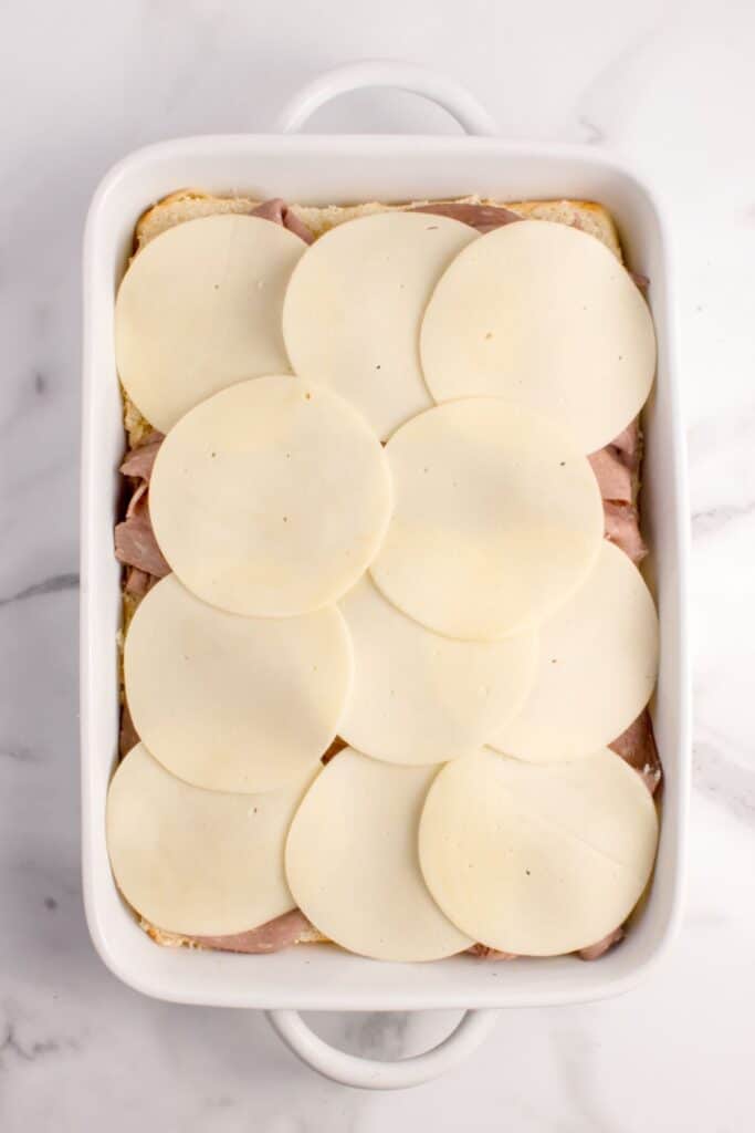 Roast beef sliders with roast beef layer and provolone cheese layers.