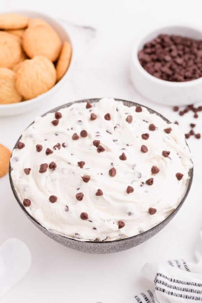 A bowl of completed cookie dough dip with sprinkled chocolate chips on top.