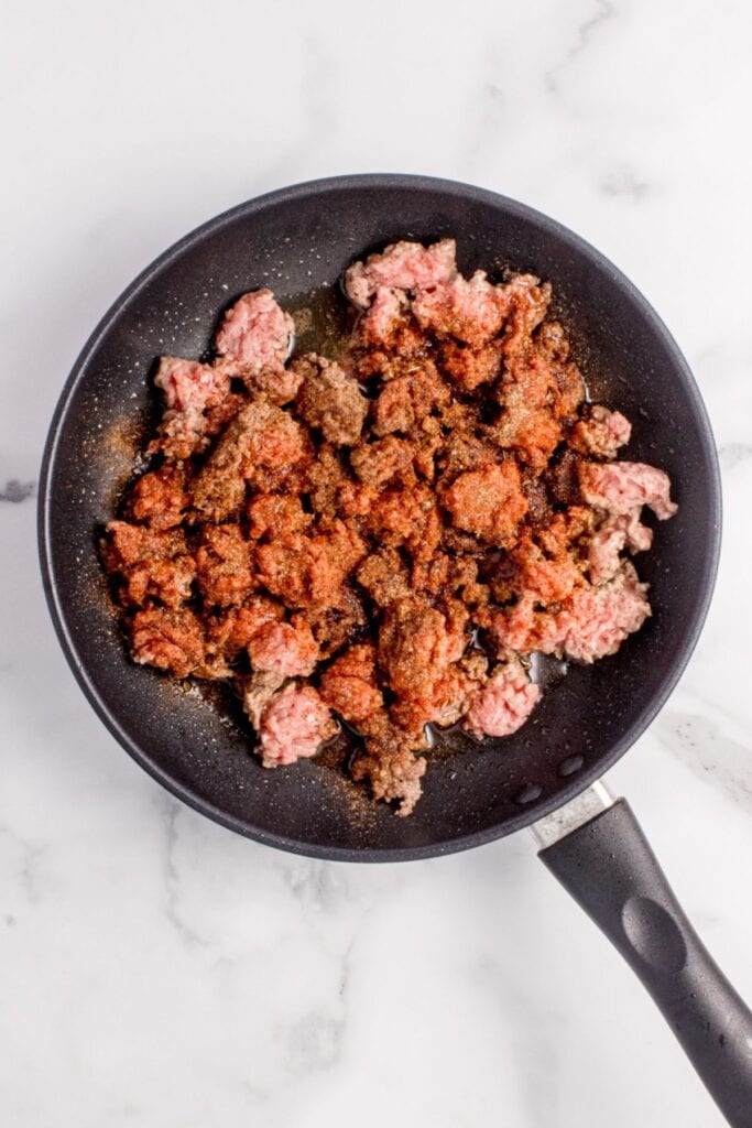 Ground beef cooking in a pan.