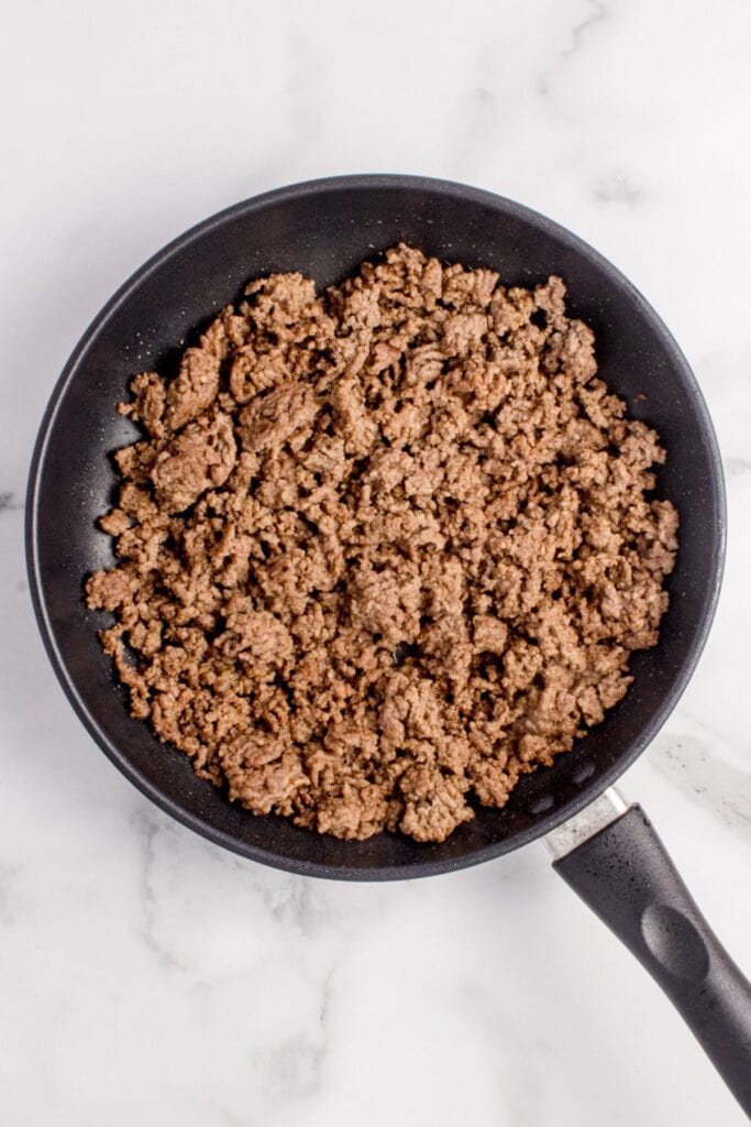 Ground beef cooked in a pan.