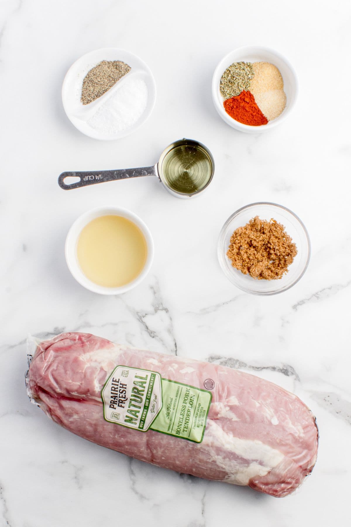 Ingredients for grilled pork tenderloin: pork tenderloin, olive oil, apple cider vinegar, salt , black pepper, brown sugar, onion powder, garlic powder, smoked paprika, and Italian seasoning.