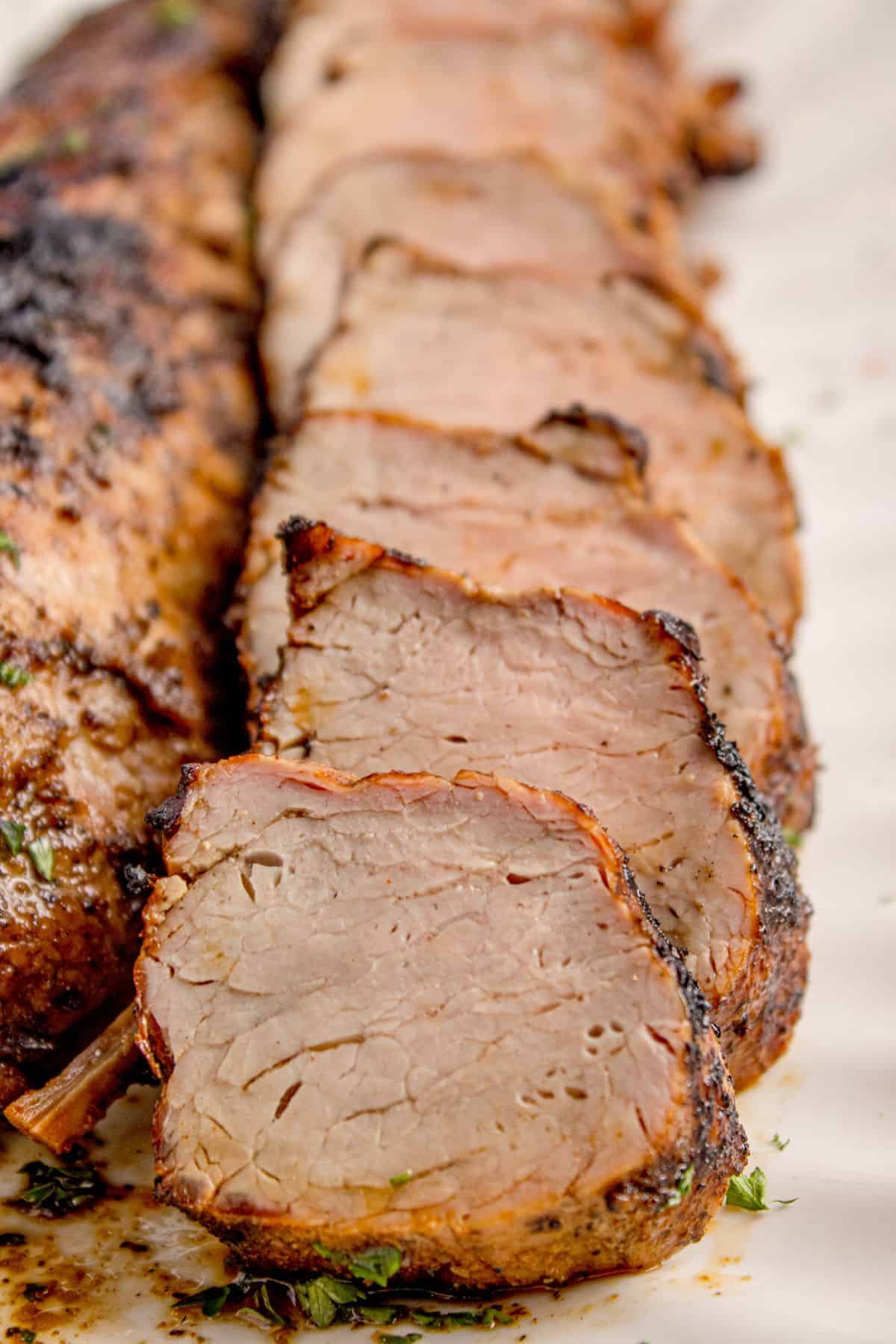 Close up of the grilled pork tenderloin recipe cut into medallions to see the tender inside.