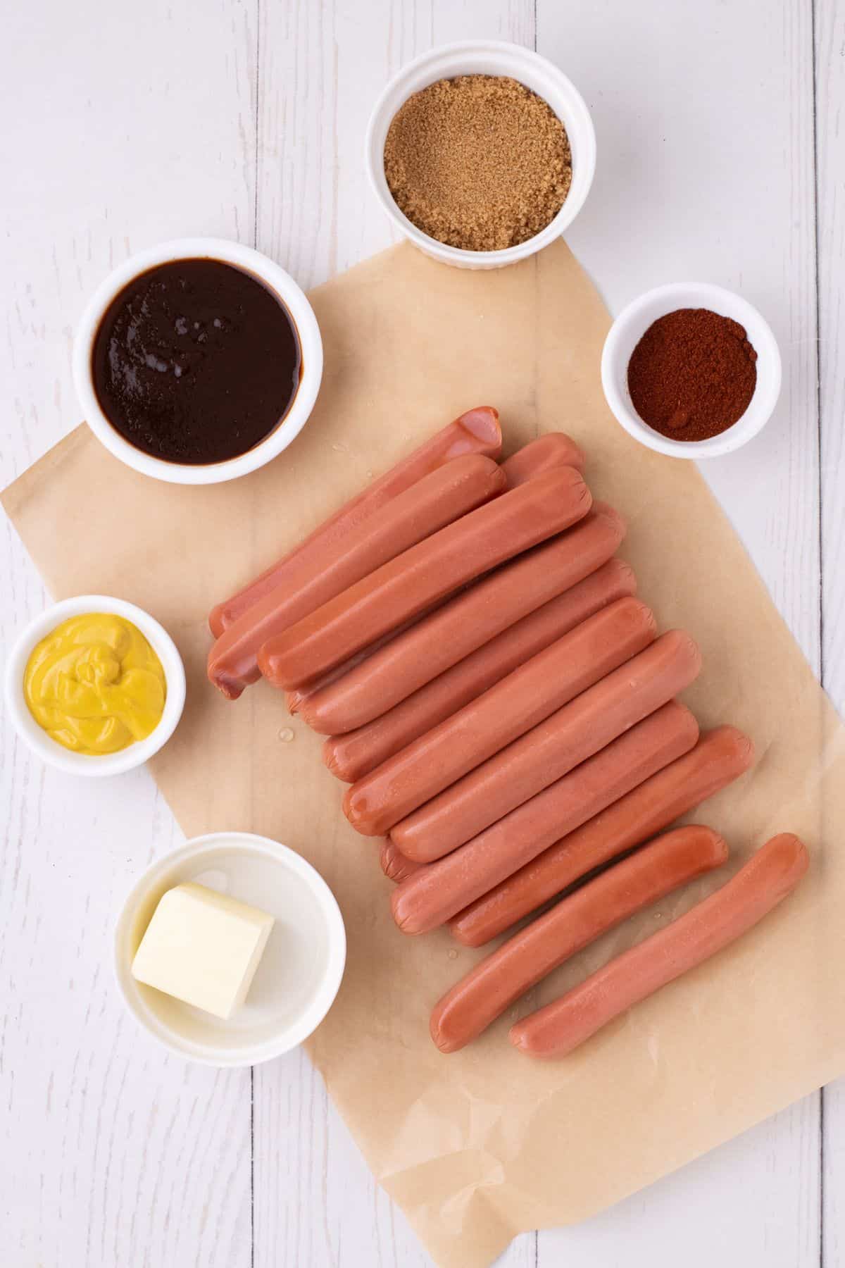 Ingredients for hot dog burnt ends: Hot dogs, smoked paprika, BBQ sauce, yellow mustard, and butter.