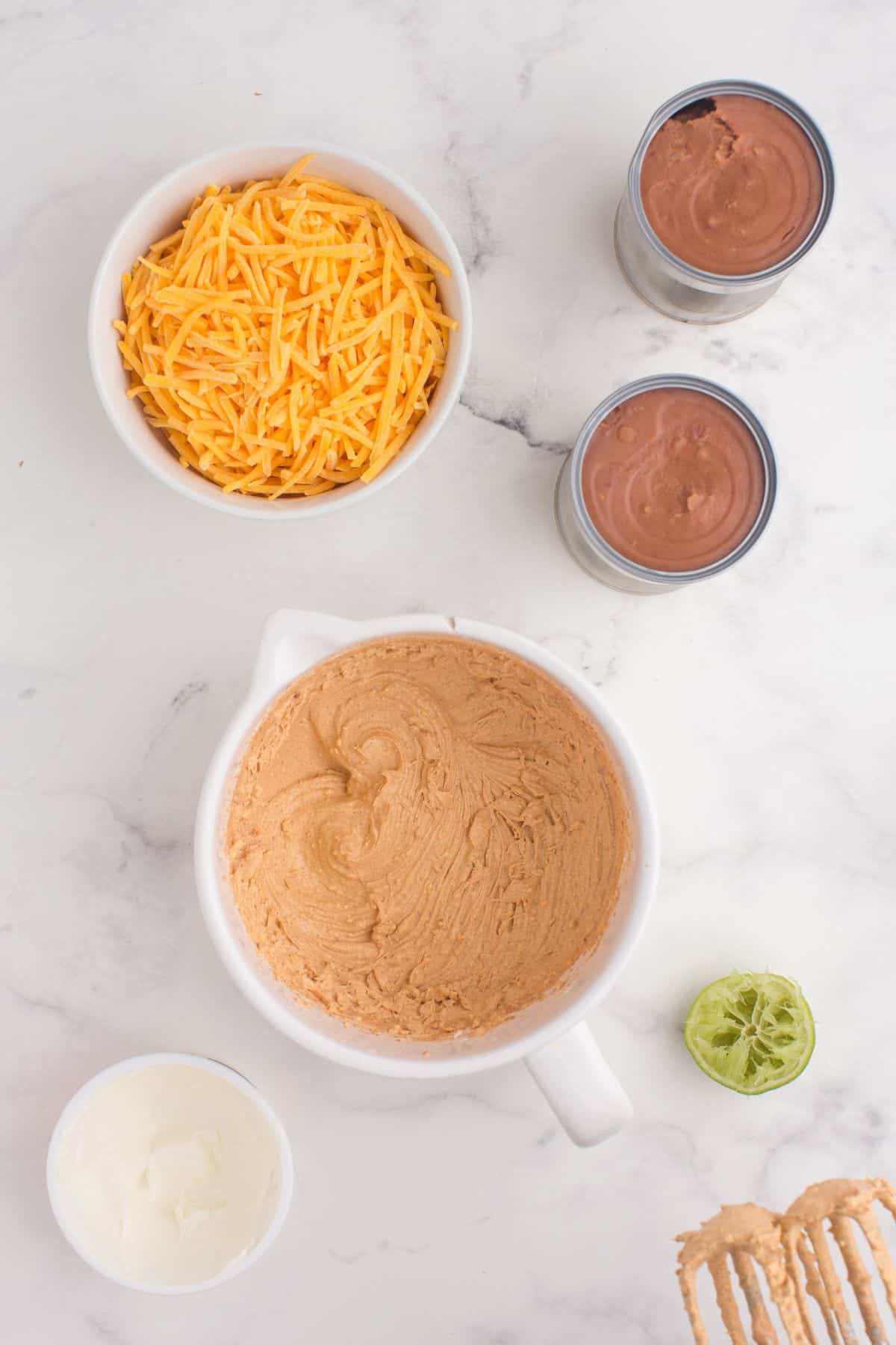 Sour cream, seasoning mix, lime juice, and cream cheese have been whipped together in a mixing bowl.