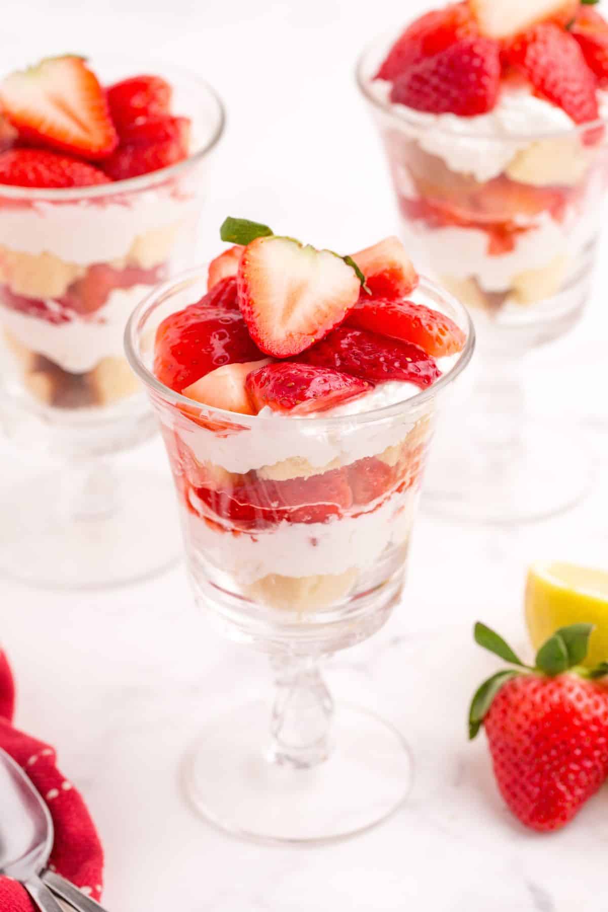 Completed strawberry parfait in three tall glasses.