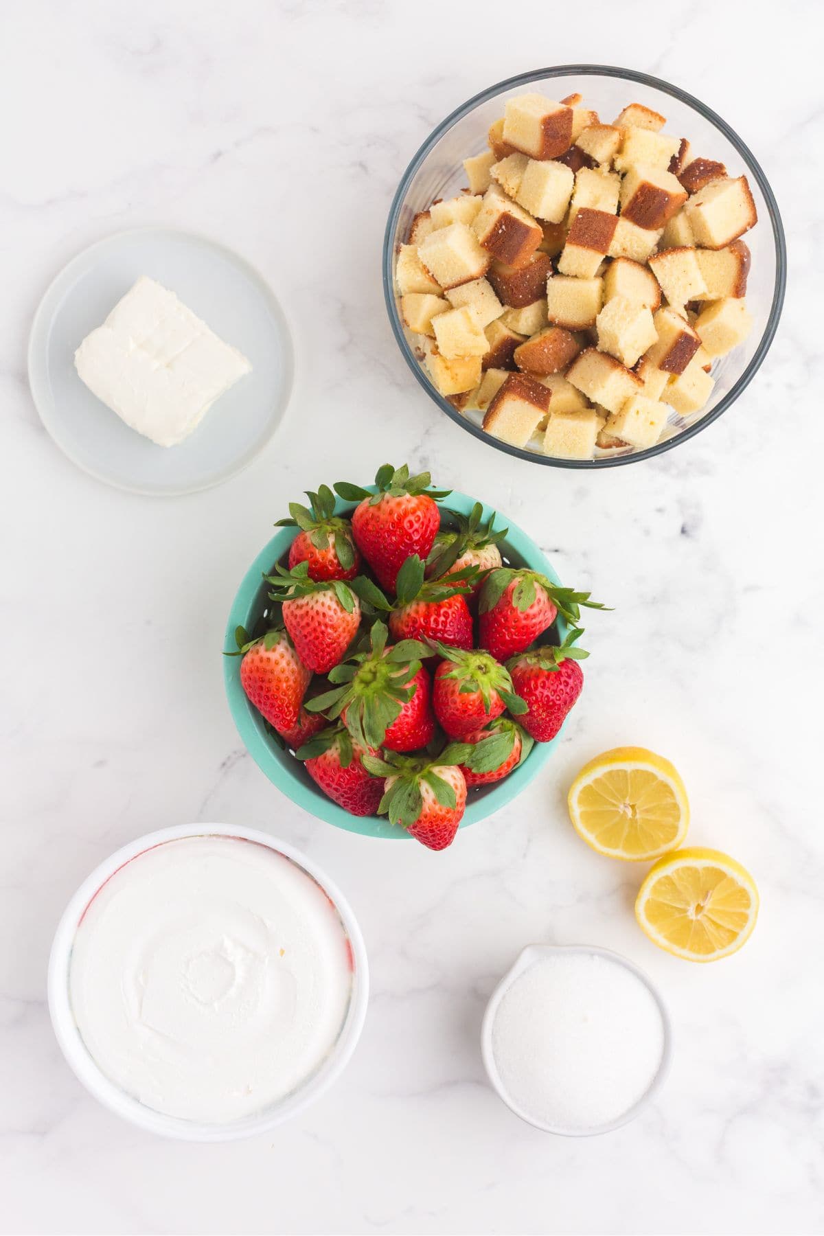 Ingredients for strawberry parfait: pound cake, cream cheese, strawberries, Cool Whip, sugar, and lemon.