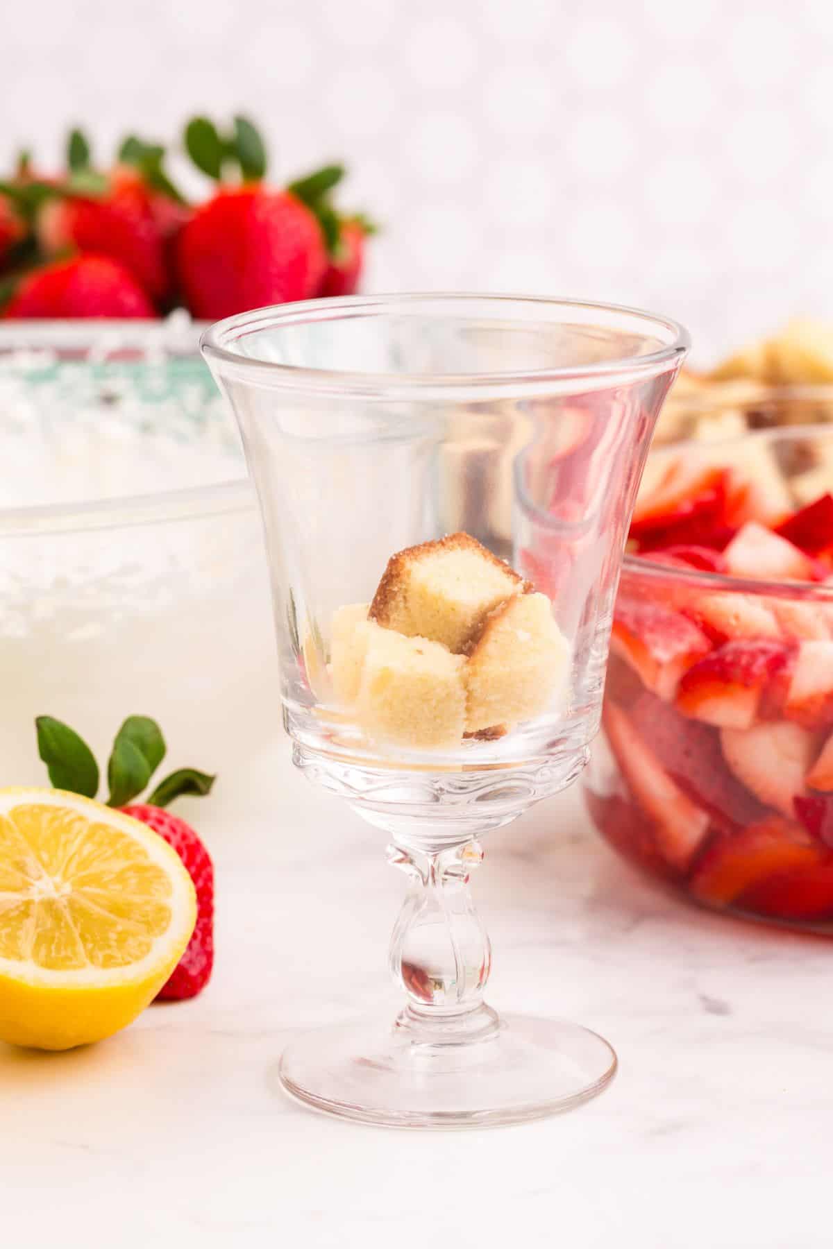 A layer of pound cake in a tall glass.