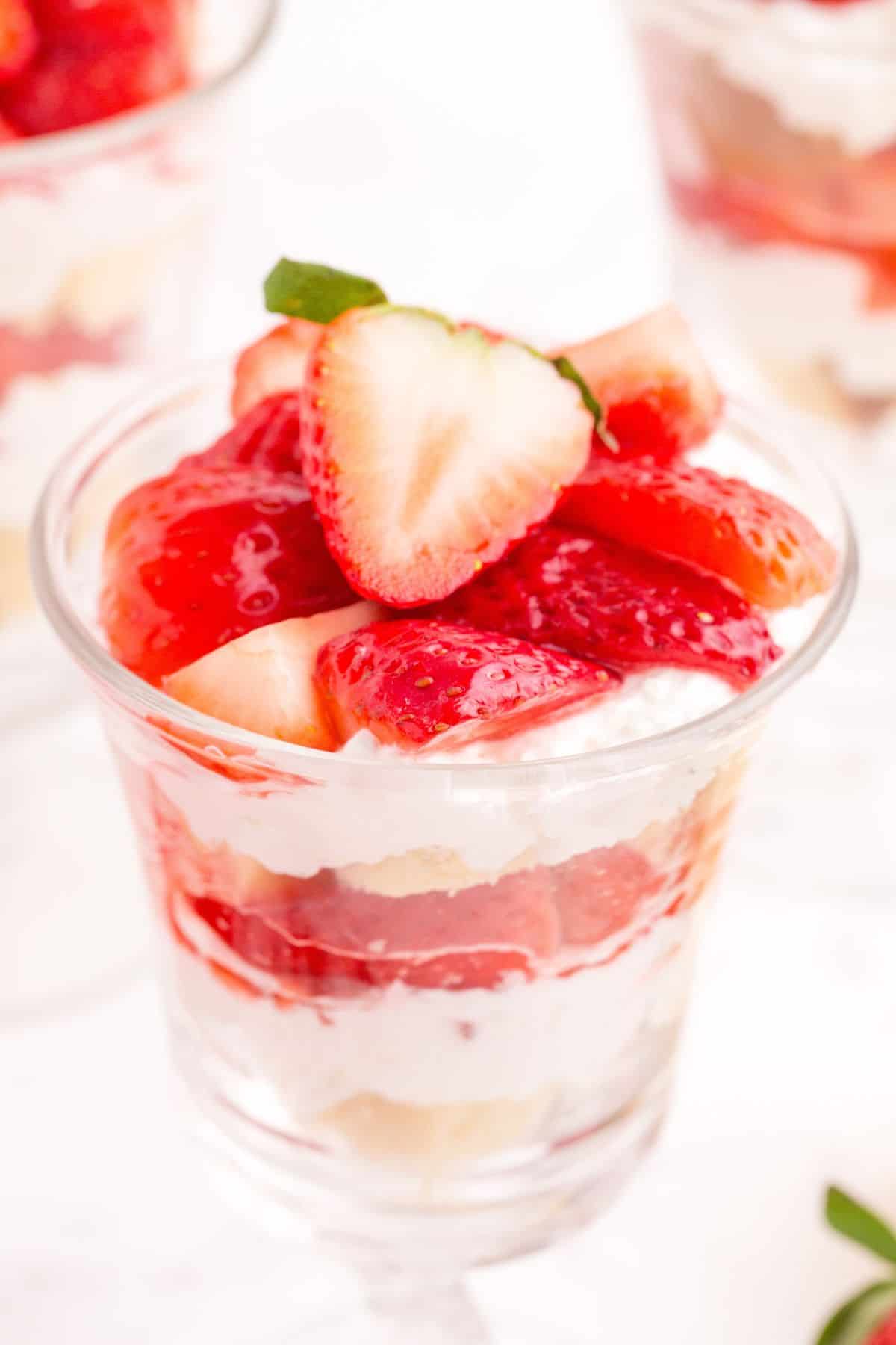 Completed strawberry parfait in a tall glass.