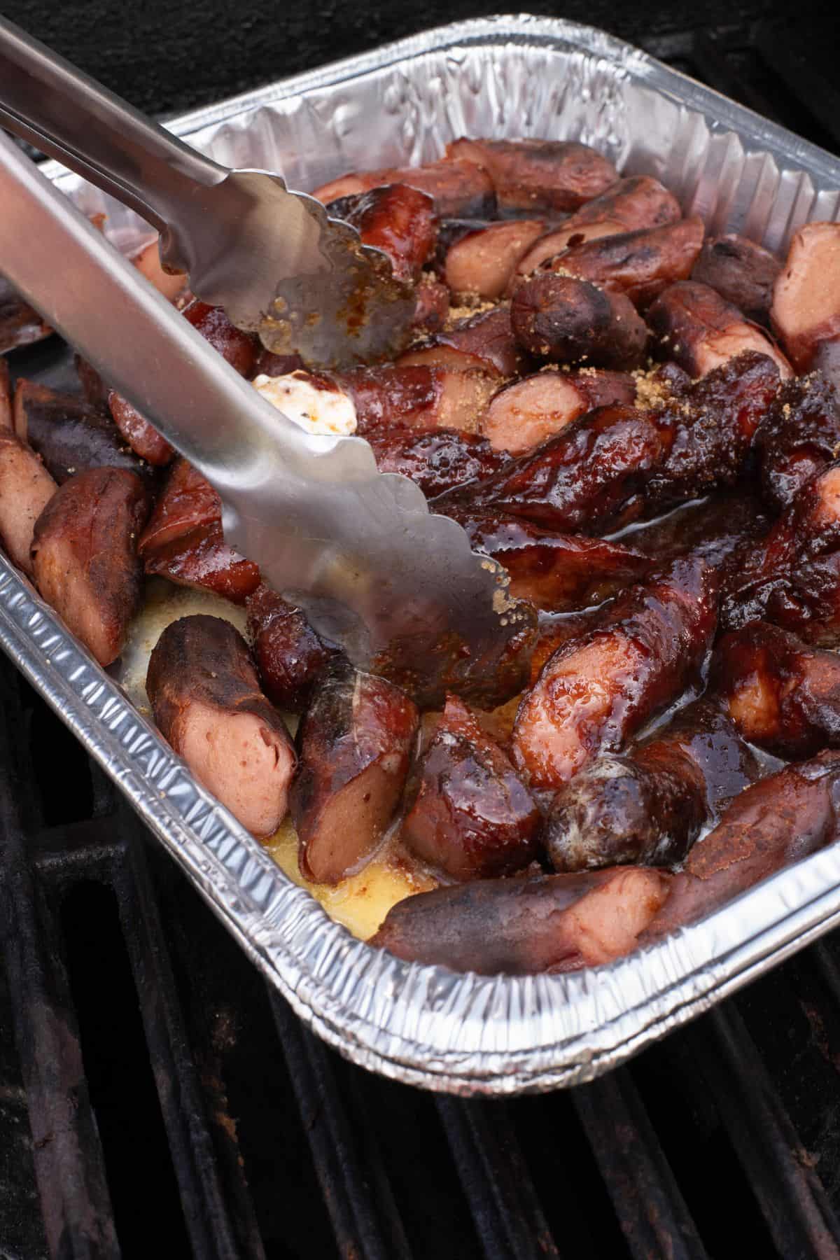 Burnt end hot dogs being mixed with brown sugar and other ingredients to get flavor.