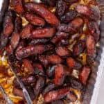 Hot dog burnt ends in a aluminum baking dish.