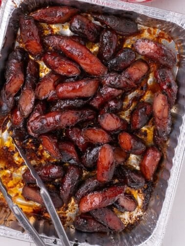 Hot dog burnt ends in a aluminum baking dish.