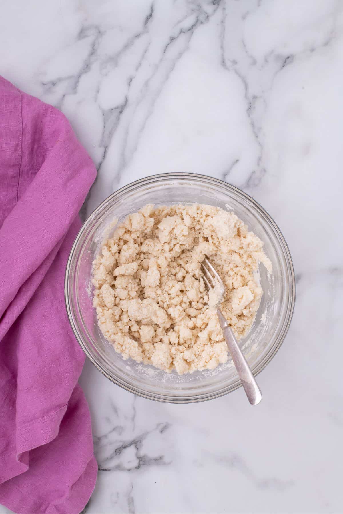 Cake mix and butter are combined together to form a crumble.