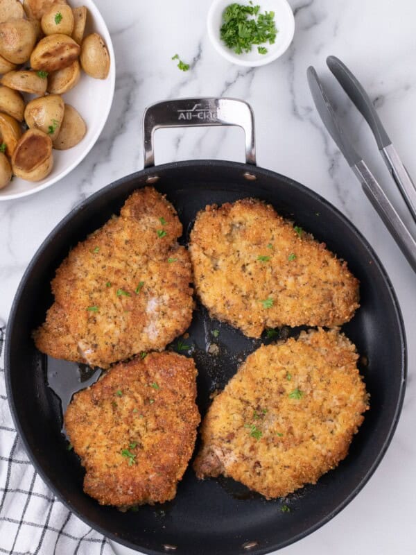 Cooked pork chops in a skillet.