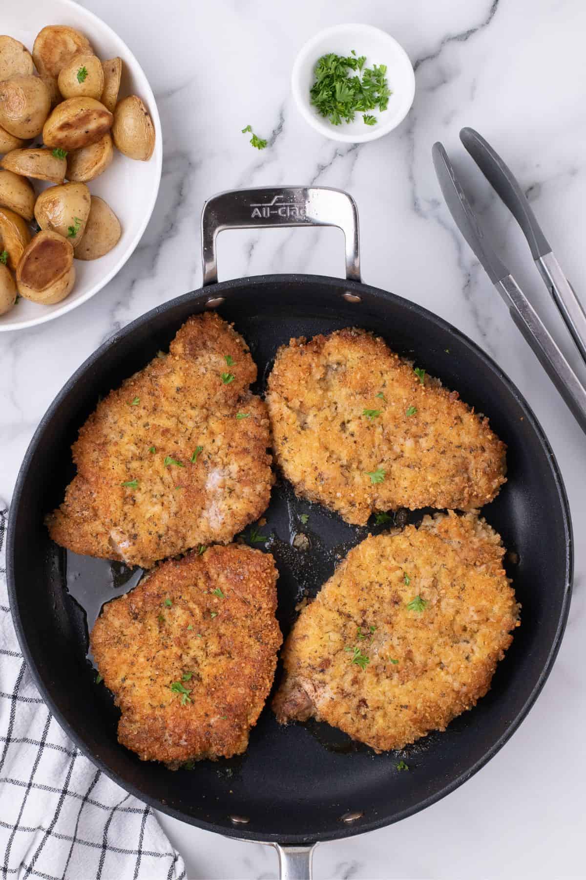 Cooked pork chops in a skillet.