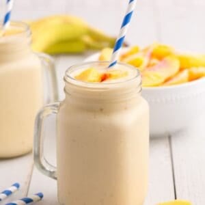 Completed peach smoothie in a glass mug.