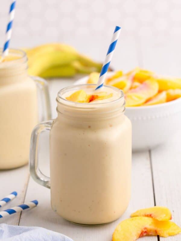 Completed peach smoothie in a glass mug.