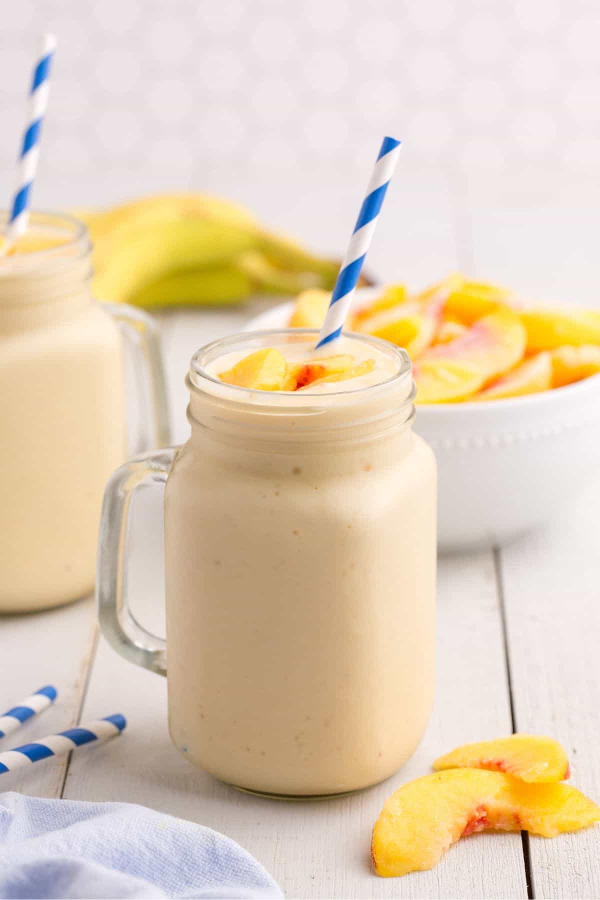 Completed peach smoothie in a glass mug.
