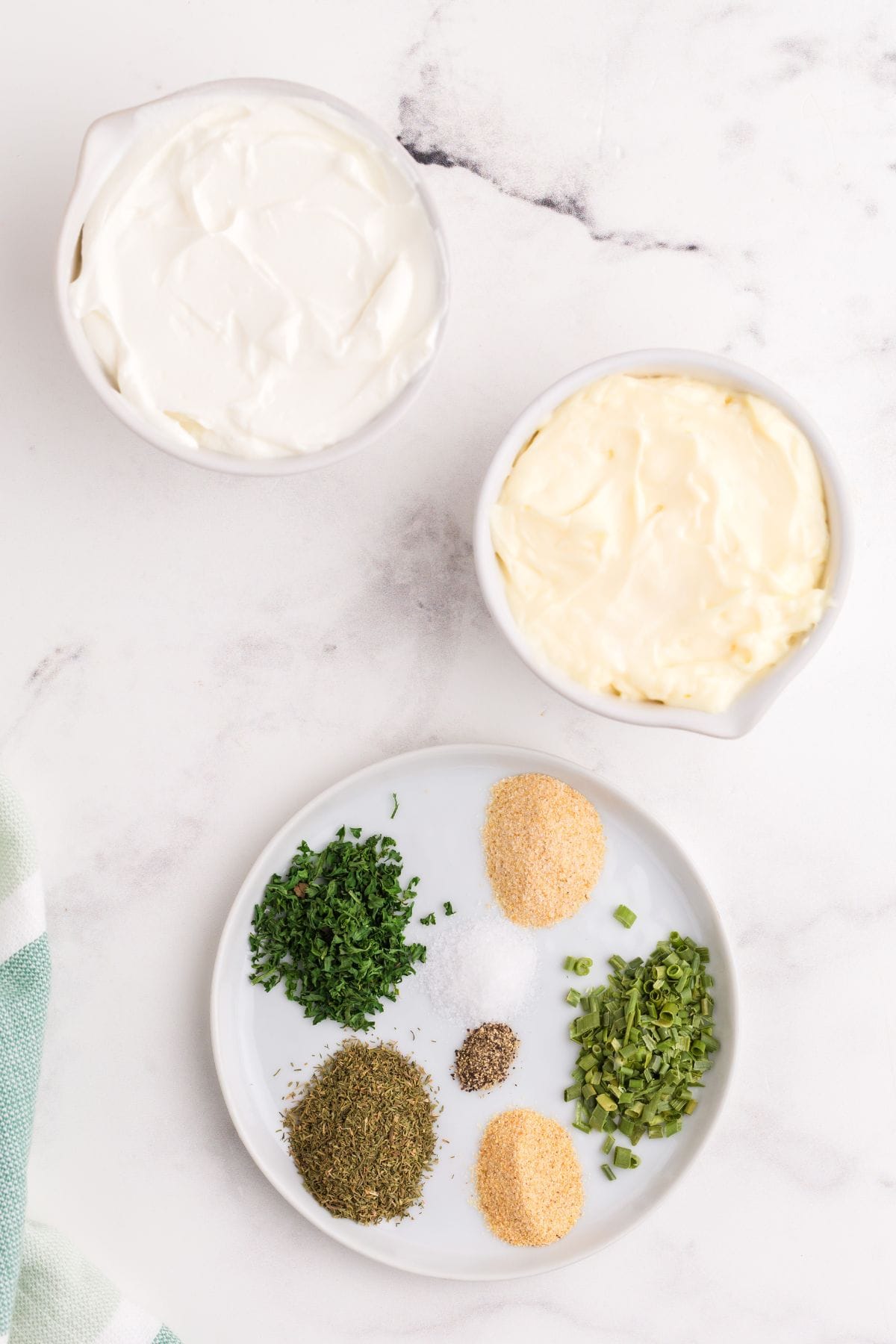 Ingredients for ranch dip: sour cream, mayonnaise, dried chives, dried dill, dried parsley, dried onion, dried garlic, salt, and pepper.
