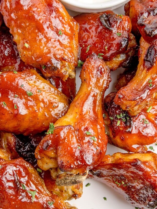 Close up of BBQ wings on a serving plate with blue cheese.
