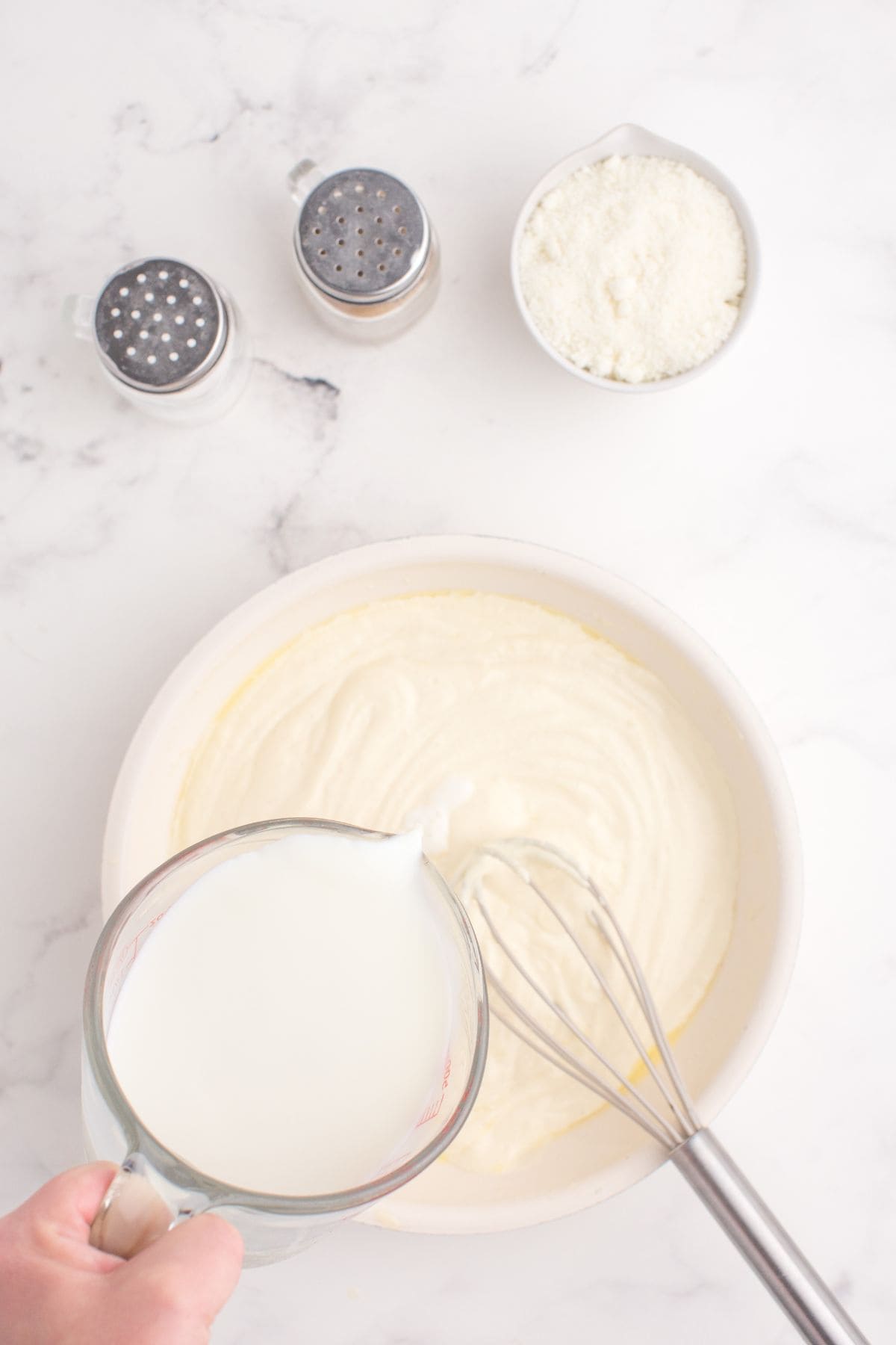 Milk added to the alfredo sauce to create the right consistency.