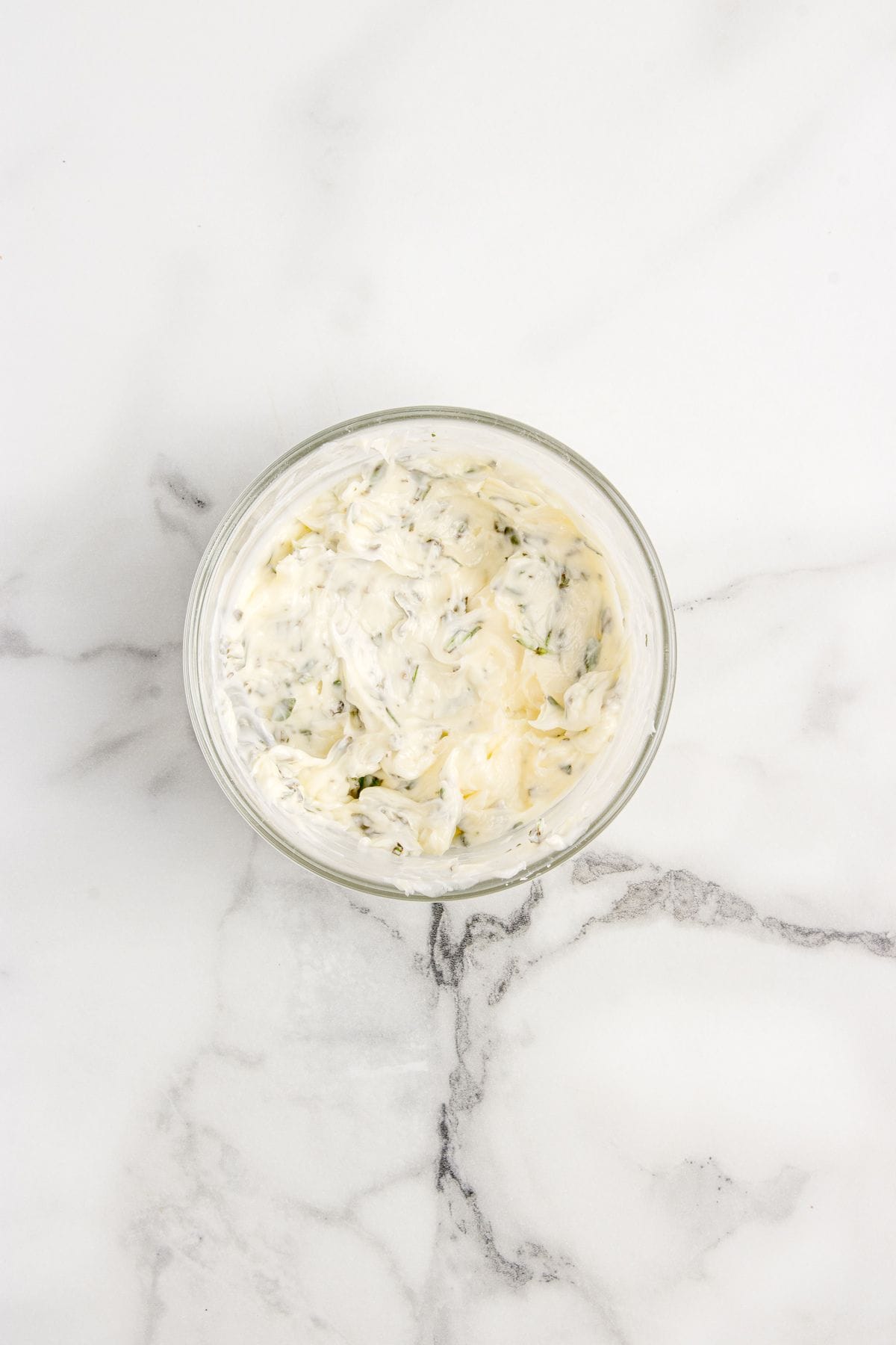 Rosemary thyme butter in a glass bowl.