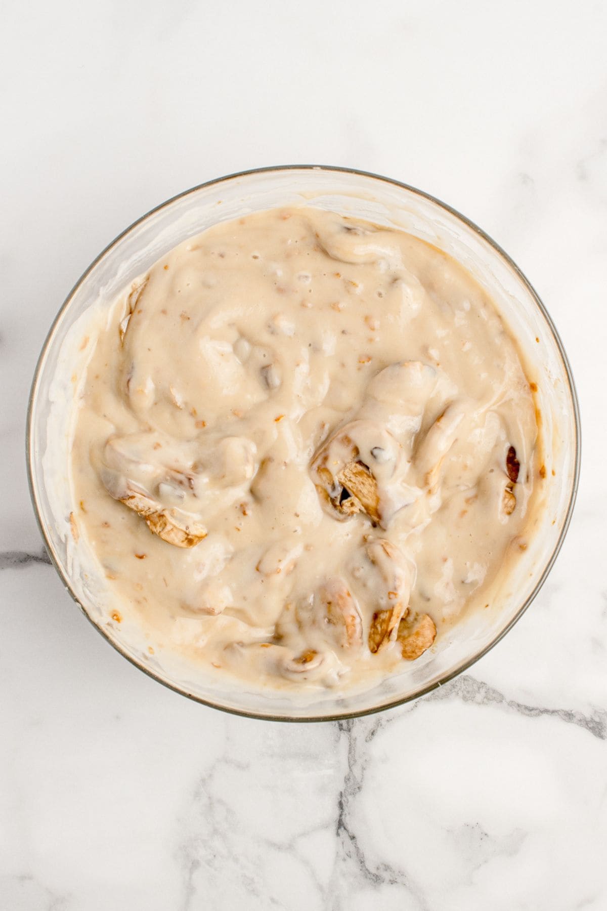 Cream of mushroom soup, dry onion soup mix, and sliced mushrooms are combined to create the mushroom soup mixture.
