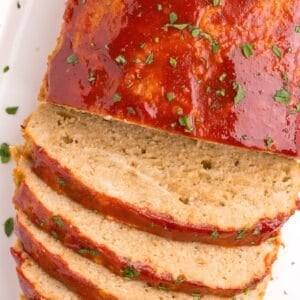 Closeup of the chicken meatloaf with half sliced.