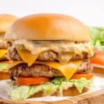 Closeup of the double smash burger recipe on a bun with toppings.